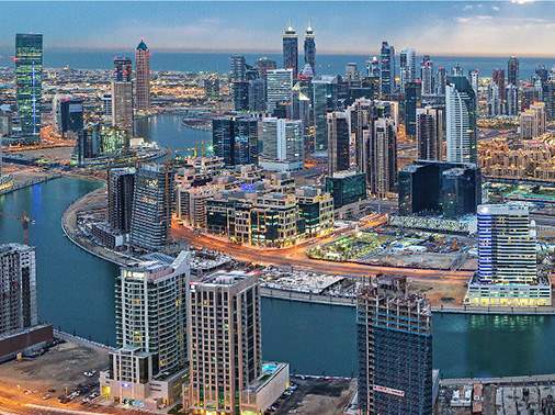 Aerial view of Business Bay at dusk showing tower density along the Dubai Water Canal